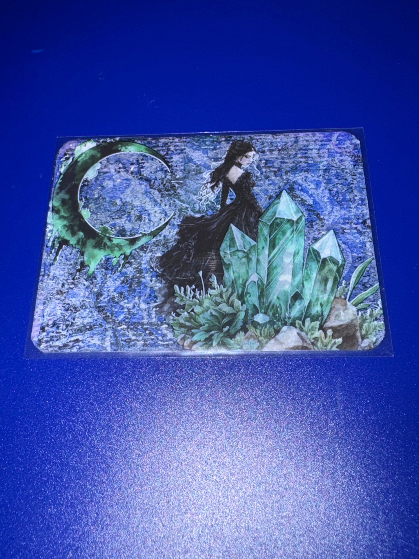 Decorative painting with a woman, crystals, and moon design on a blue background