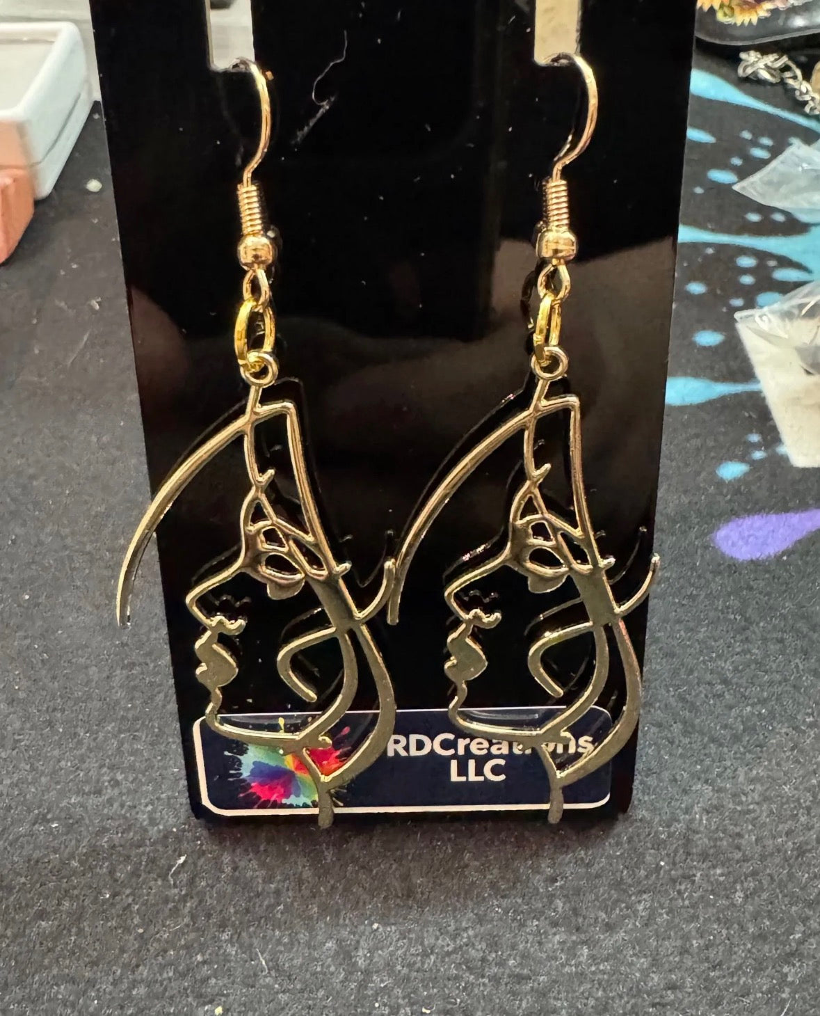 Gold color female face earrings .