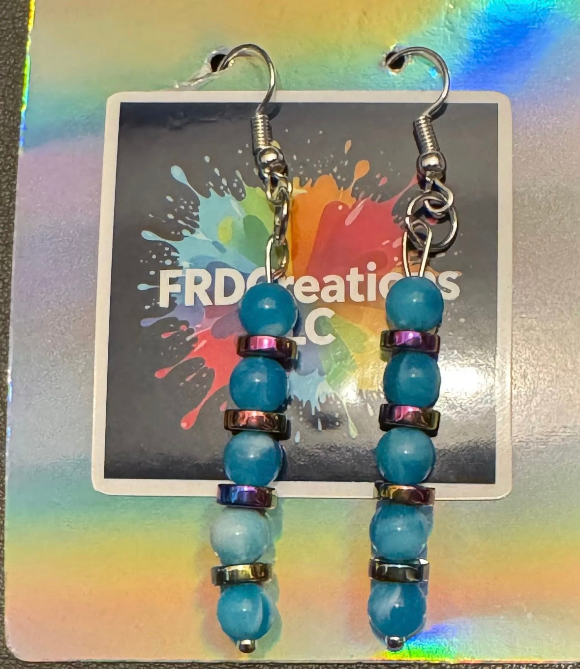 Blue Beaded earrings on a colorful card