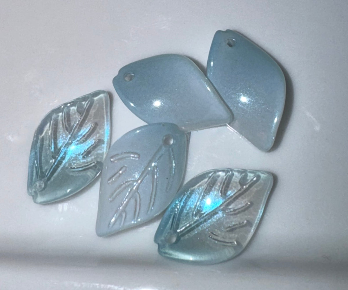 Five light blue iridescent glass leaf-shaped beads with pre-drilled holes, arranged on a white background.
