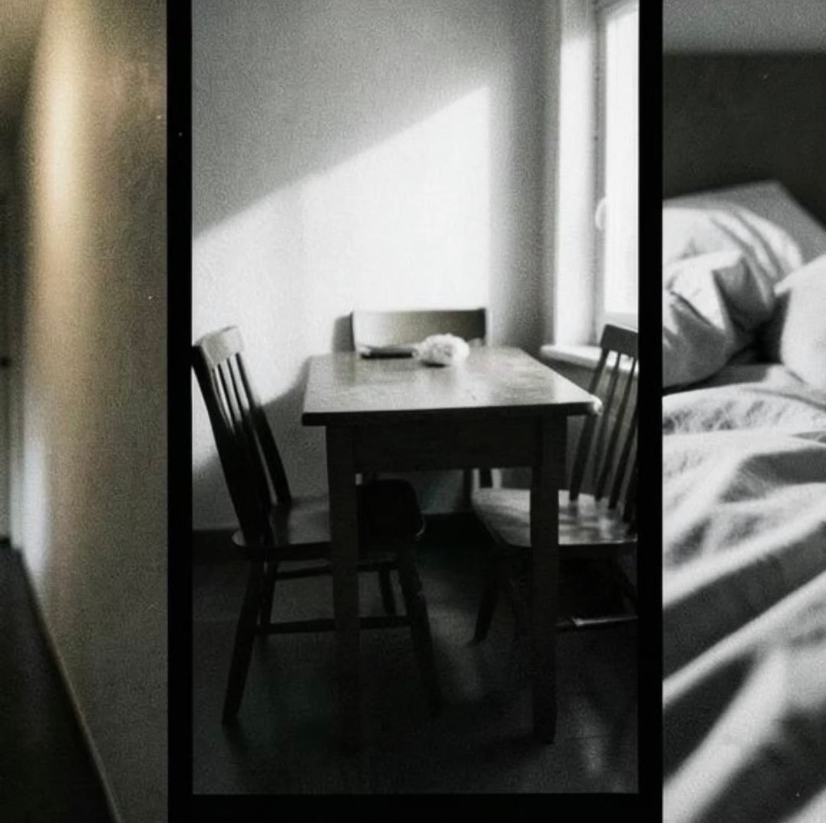 A black and white artistic triptych-style photograph featuring a dimly lit wooden dining table with two chairs in a room, with a third panel showing a bed with rumpled sheets.