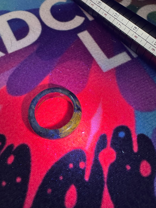Lapis Lazuli Ring under UV on a colorful fabric.