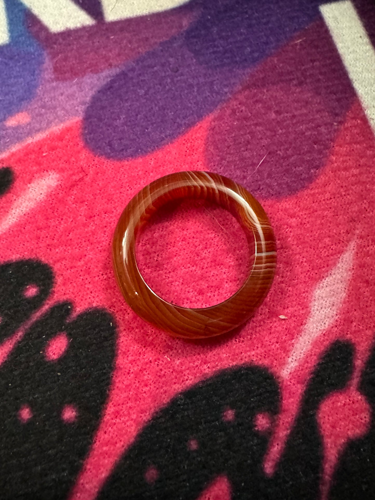 Carnelian ring on a colorful fabric background