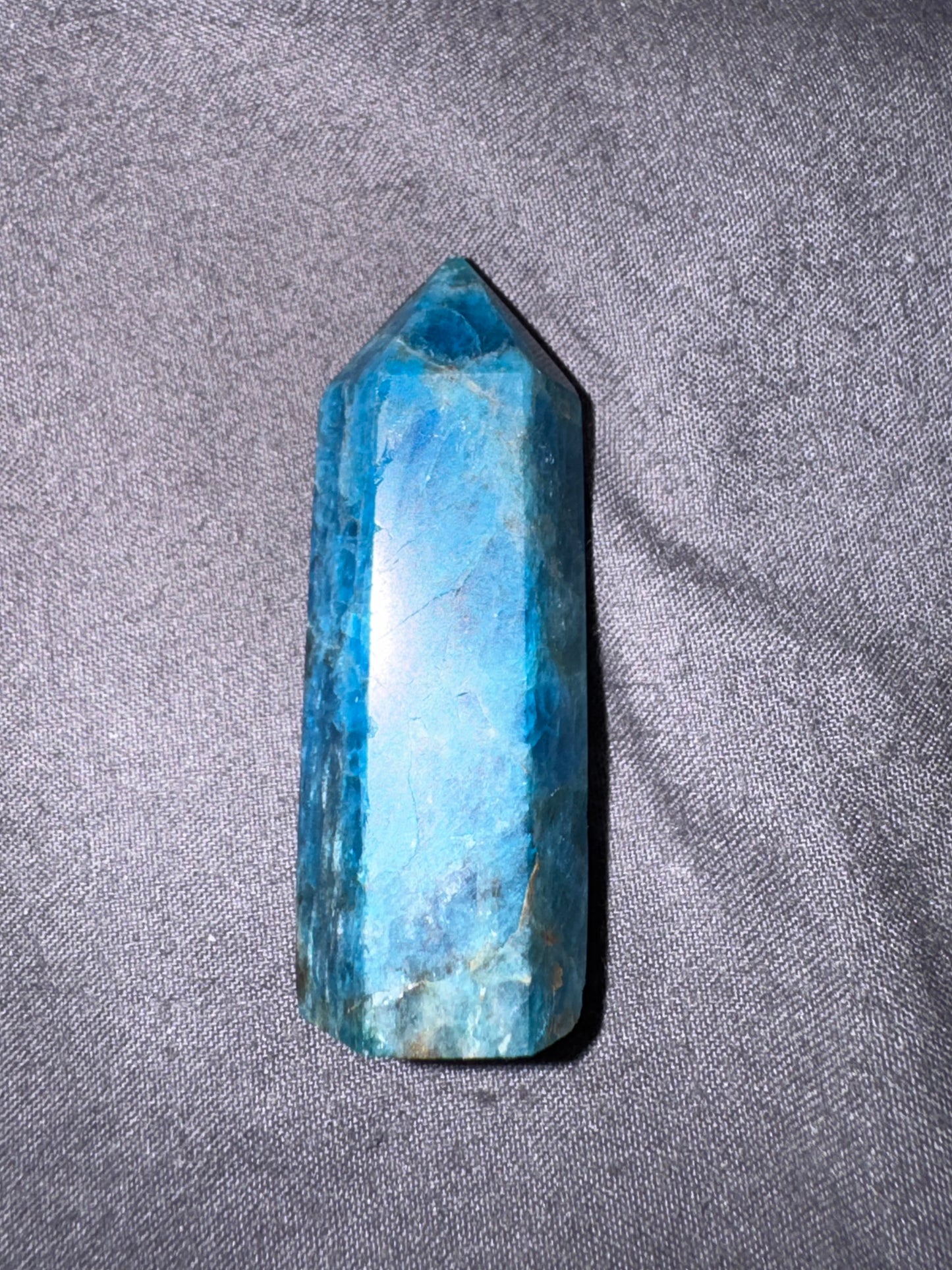 Blue crystal on a gray fabric background