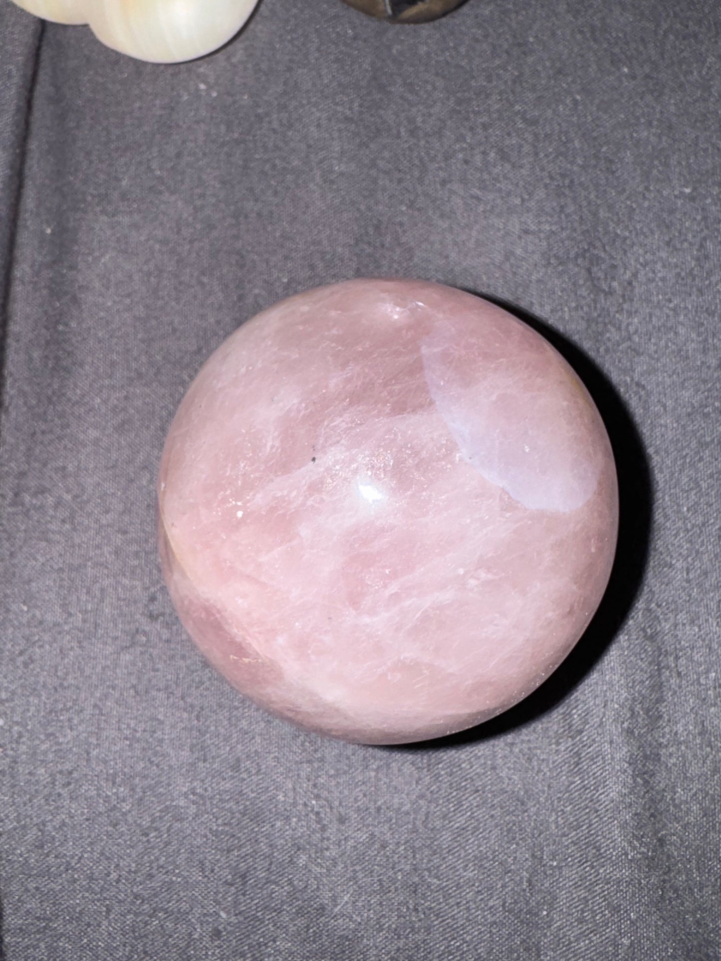 Pink stone on a gray fabric background
