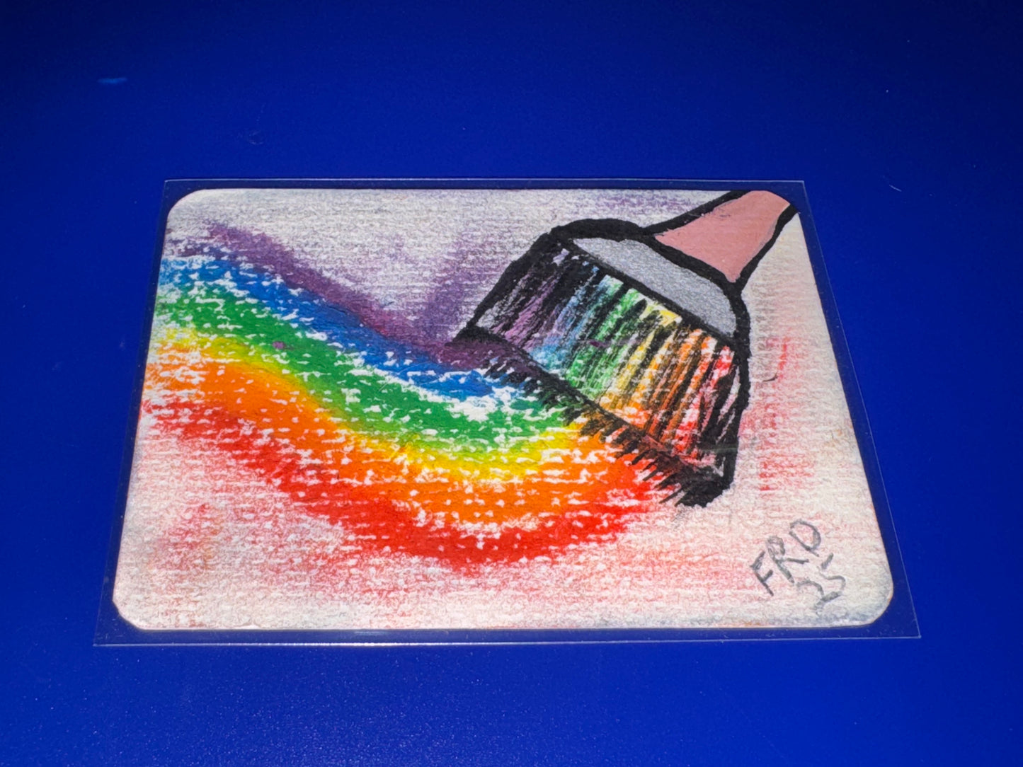 Colorful drawing of a paint brush with a rainbow pattern on a clear background