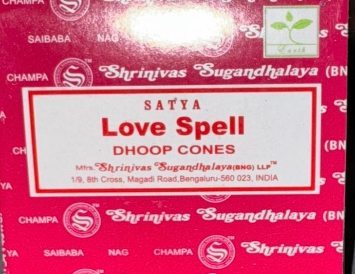 Red and white box packaging for Satya Love Spell Dhoop Cones by Shrinvas Sugandhalaya, featuring a white central label with red text on a patterned red background.