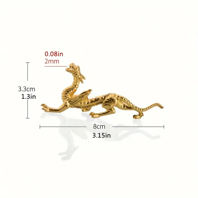 Gold dragon figurine with measurements on a white background