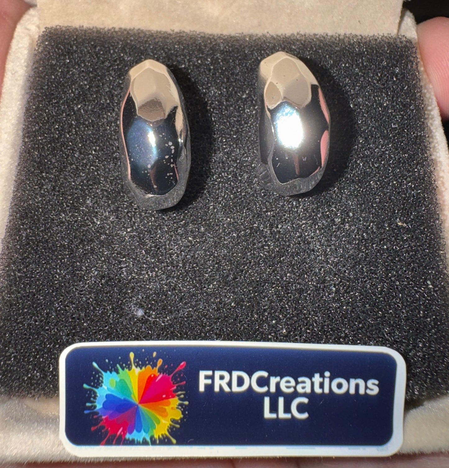 Two silver rings in a box with a FRD Creations LLC label.