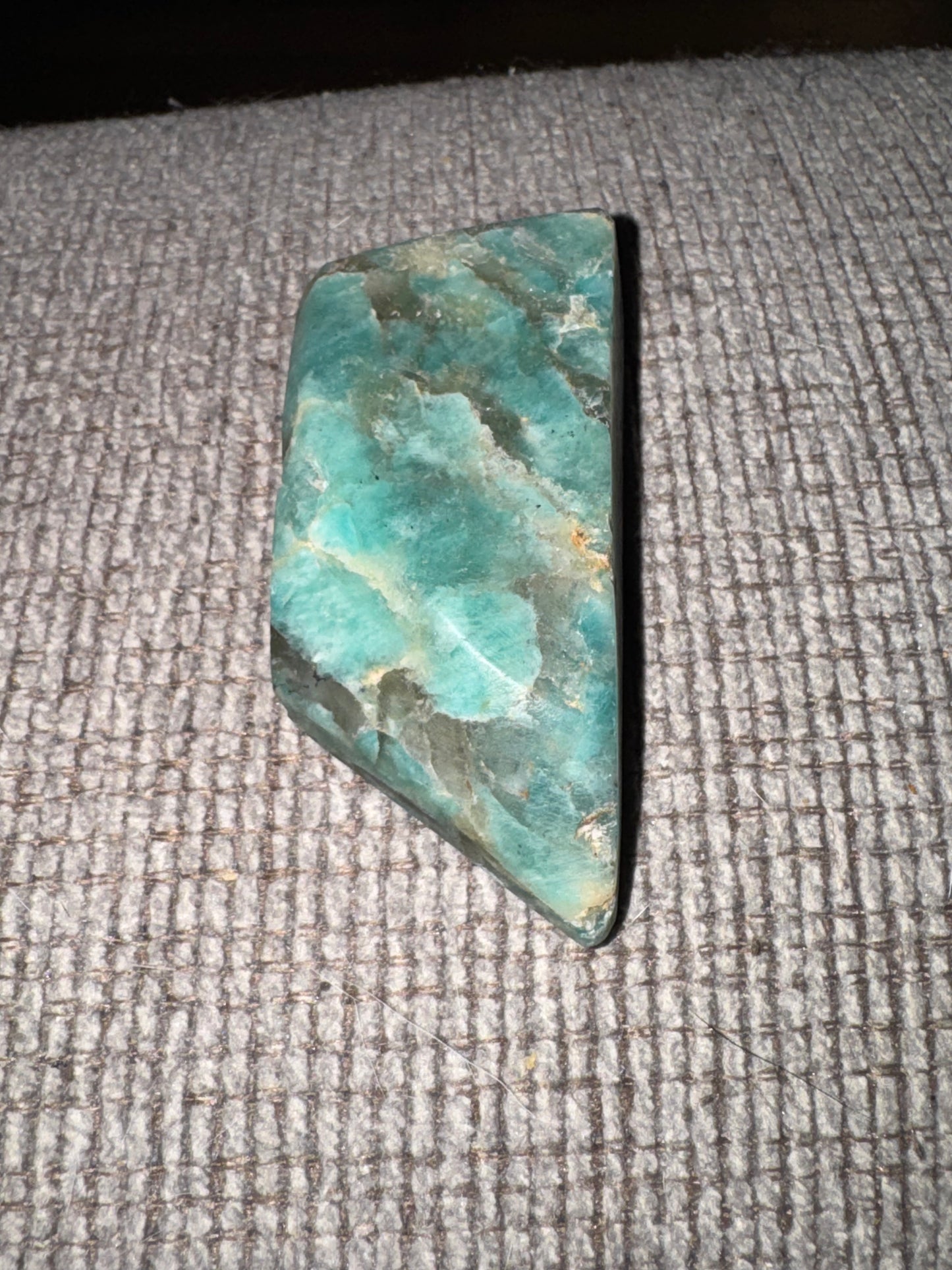 Turquoise stone on a textured gray surface