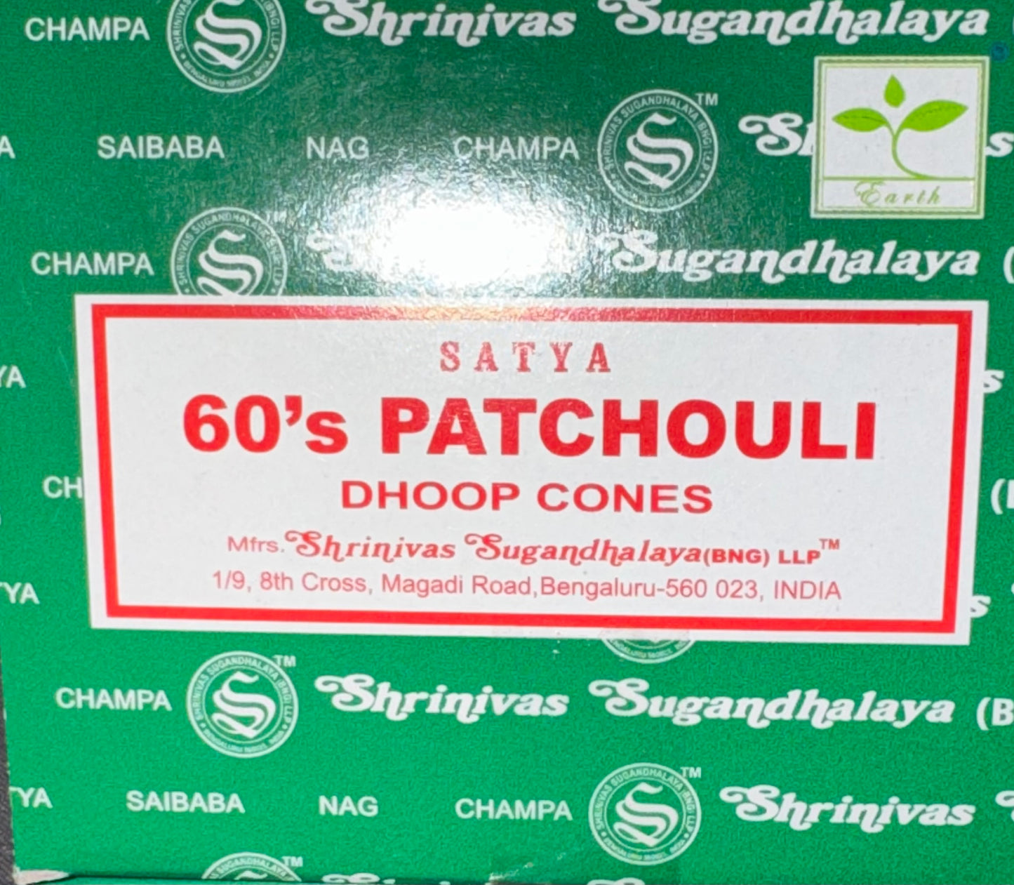 A close-up of a green box of Satya 60's Patchouli Dhoop Cones by Shrinivas Sugandhalaya, featuring a white label with red text and a glossy finish.