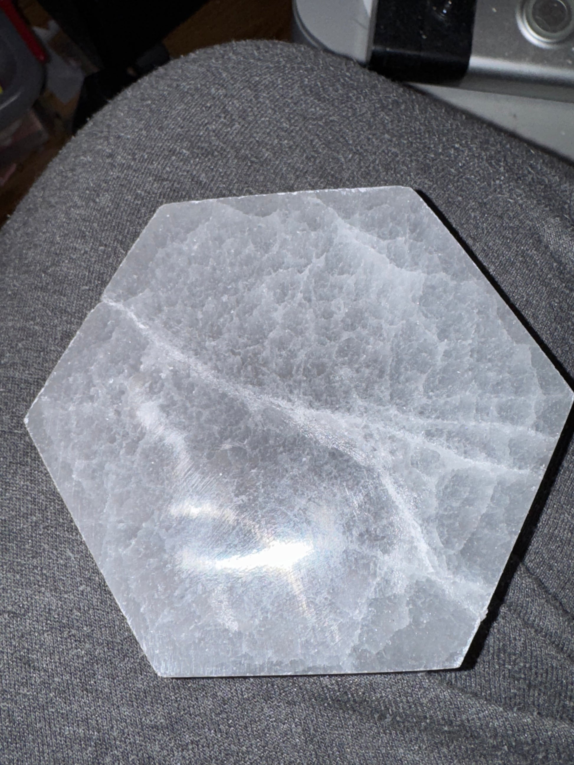 Hexagonal stone coaster on a gray surface