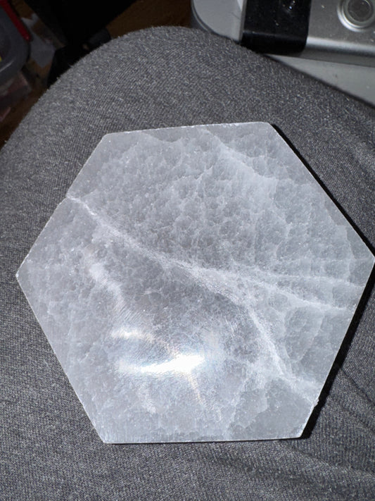 Hexagonal stone coaster on a gray surface