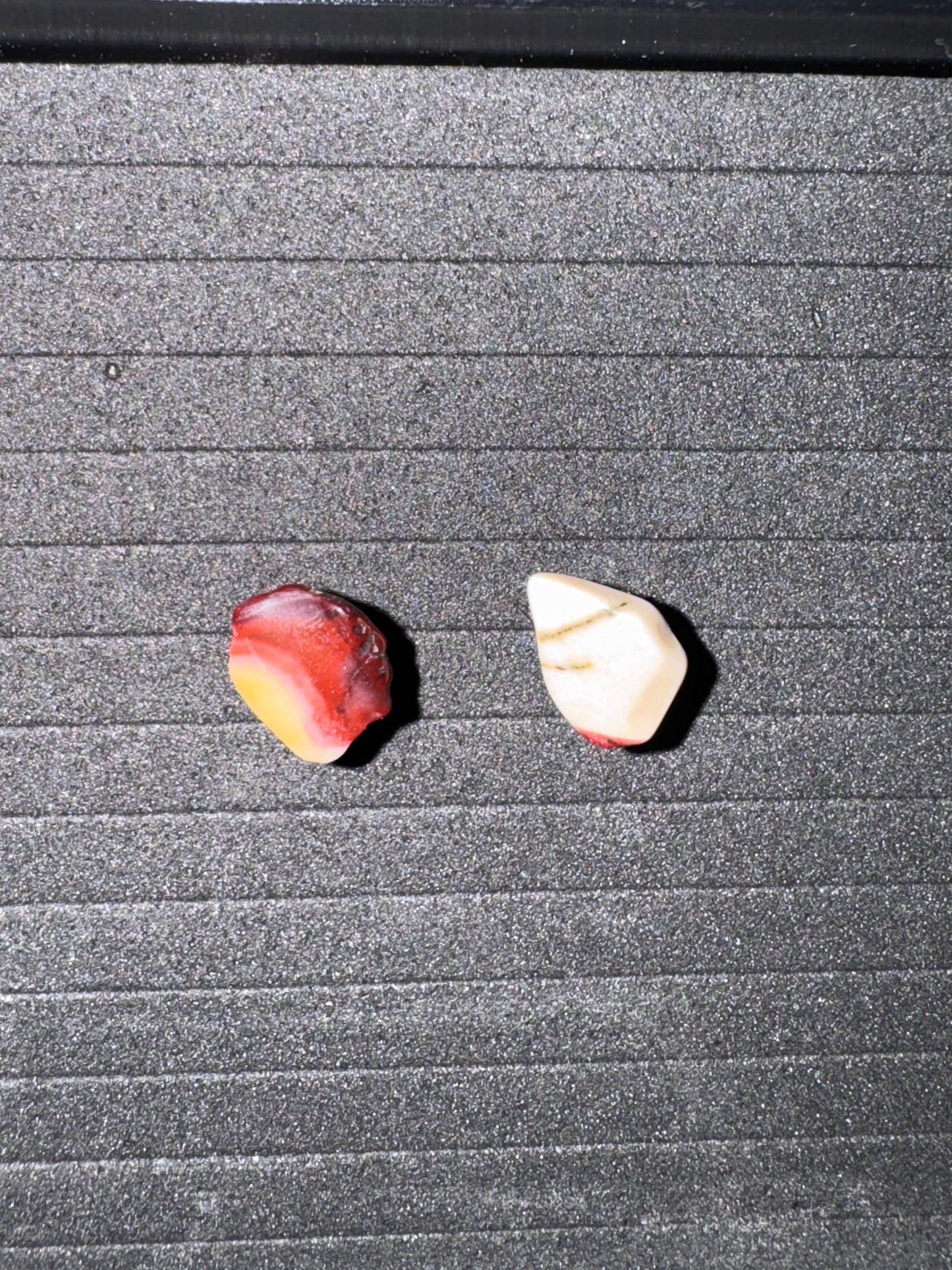 Two stones on a textured gray surface