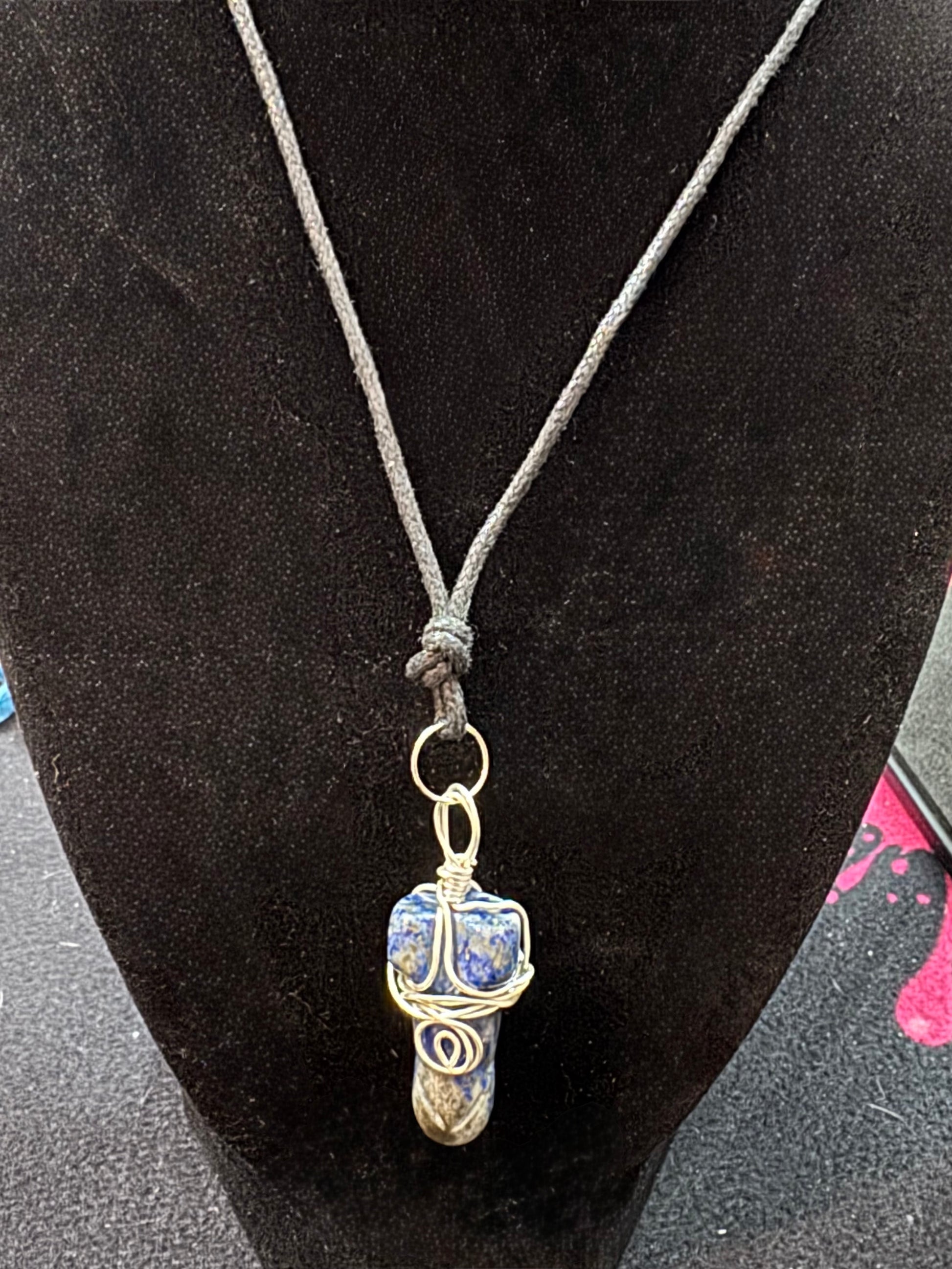 Necklace with a pendant on a black velvet stand
