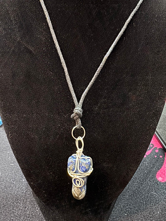 Necklace with a pendant on a black velvet stand