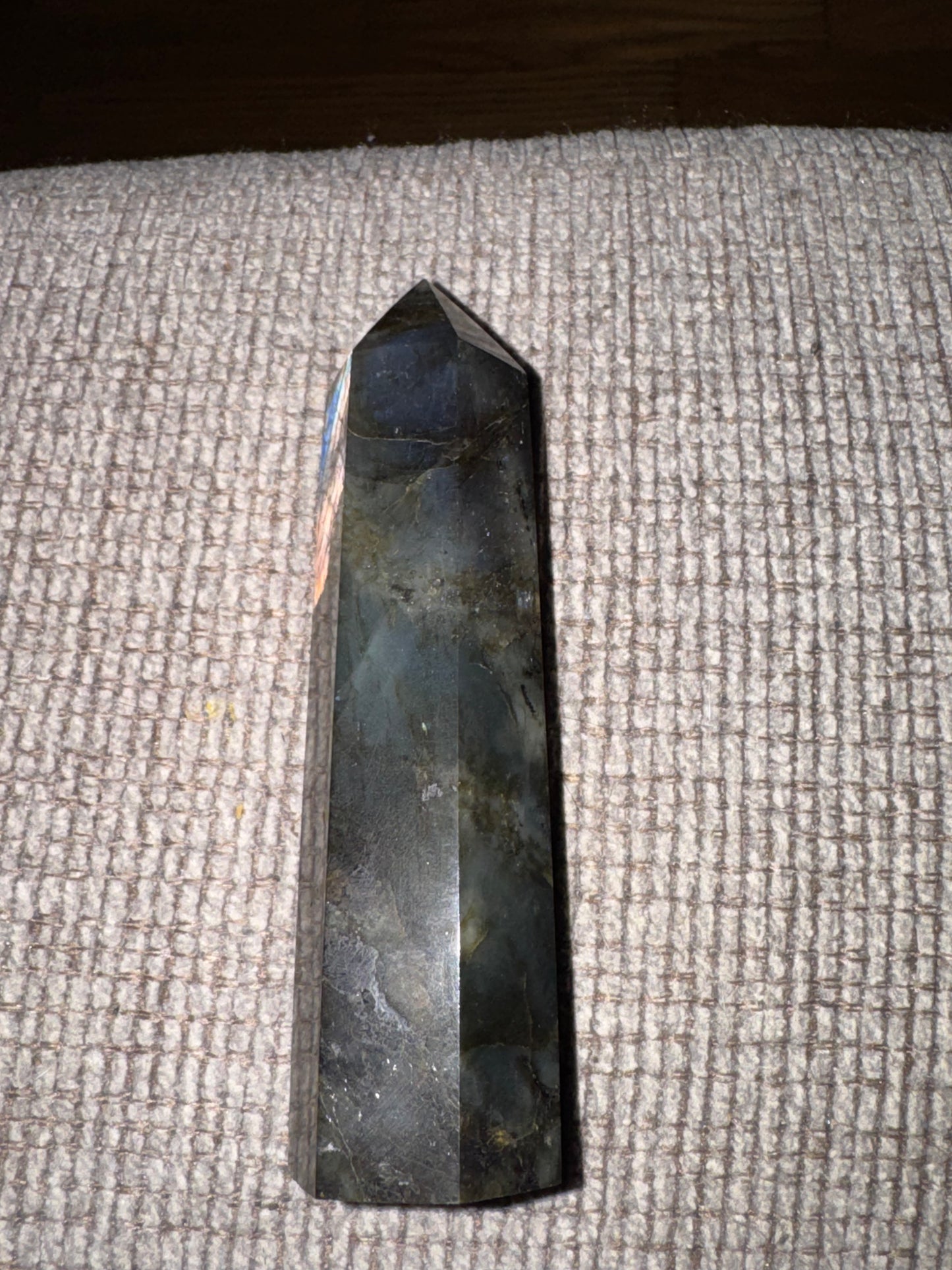 Black crystal pyramid on a textured surface