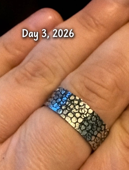 A close-up of a textured silver ring worn on a finger, with the text 'Day 3, 2026' overlaid near the top.
