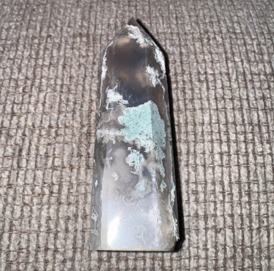 Crystal or mineral specimen on a textured surface