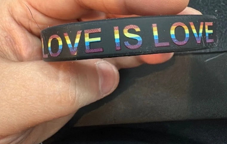 Black band with 'LOVE IS LOVE' in rainbow letters.