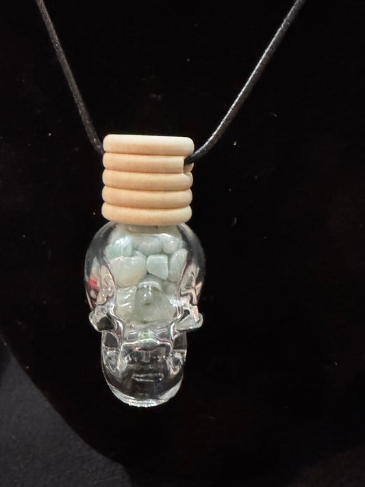 Crystal Skull filled with Caribbean Calcite Chips pendant on a black background