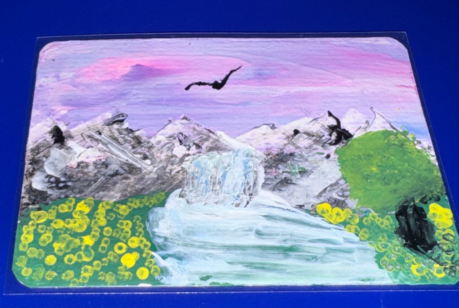 Scenic painting of mountains, waterfall, and birds with a blue background