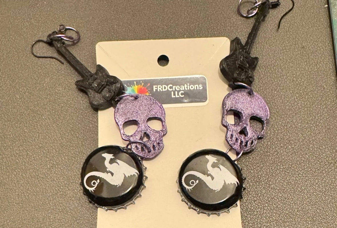 Skull-shaped earrings with bottle cap designs 