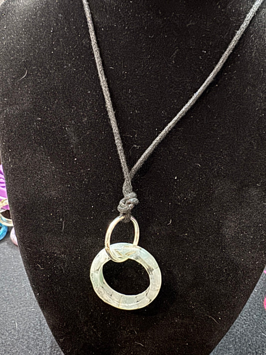 Necklace with a unique circular pendant on a black surface