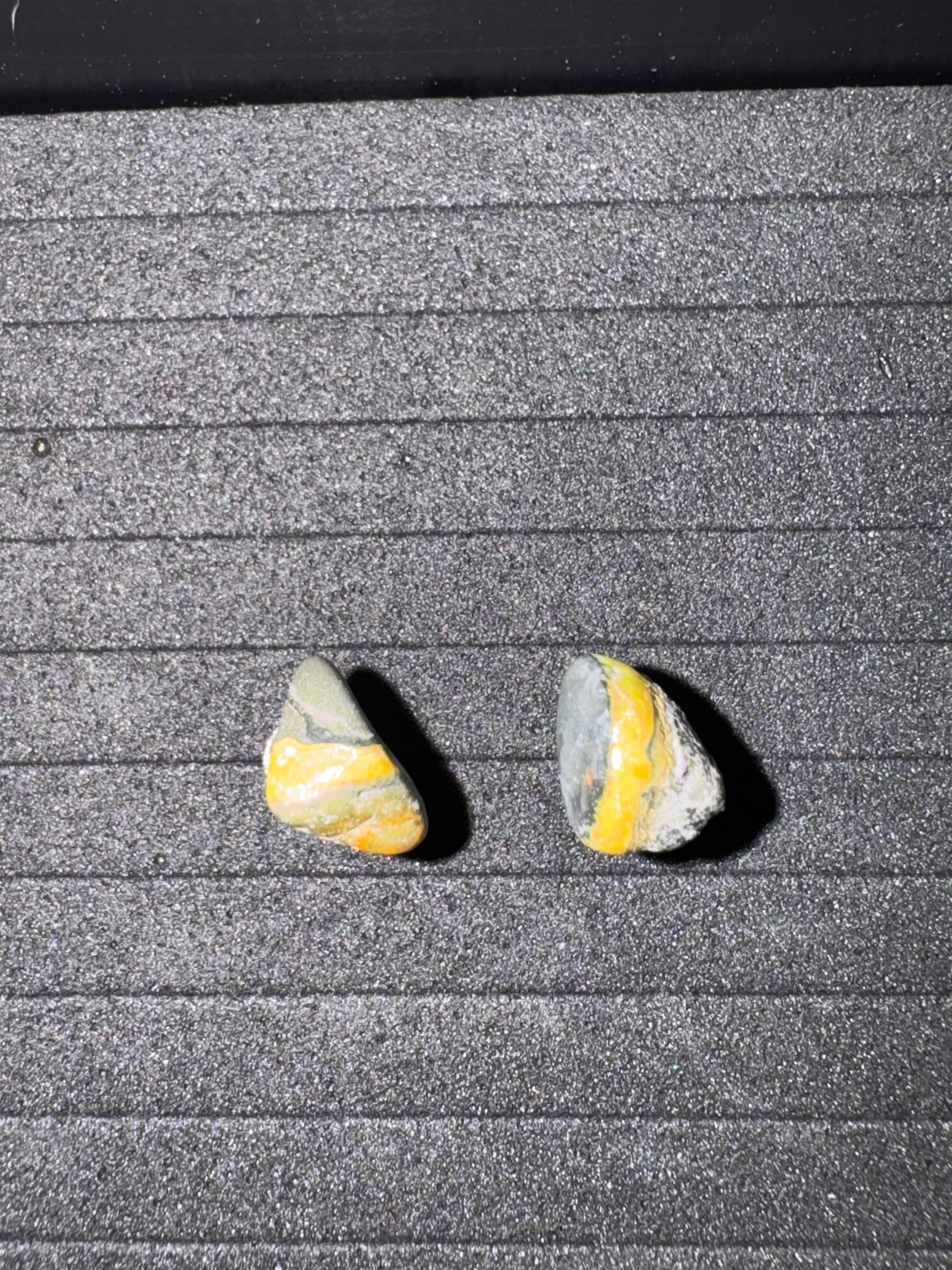 Two small stones on a textured surface