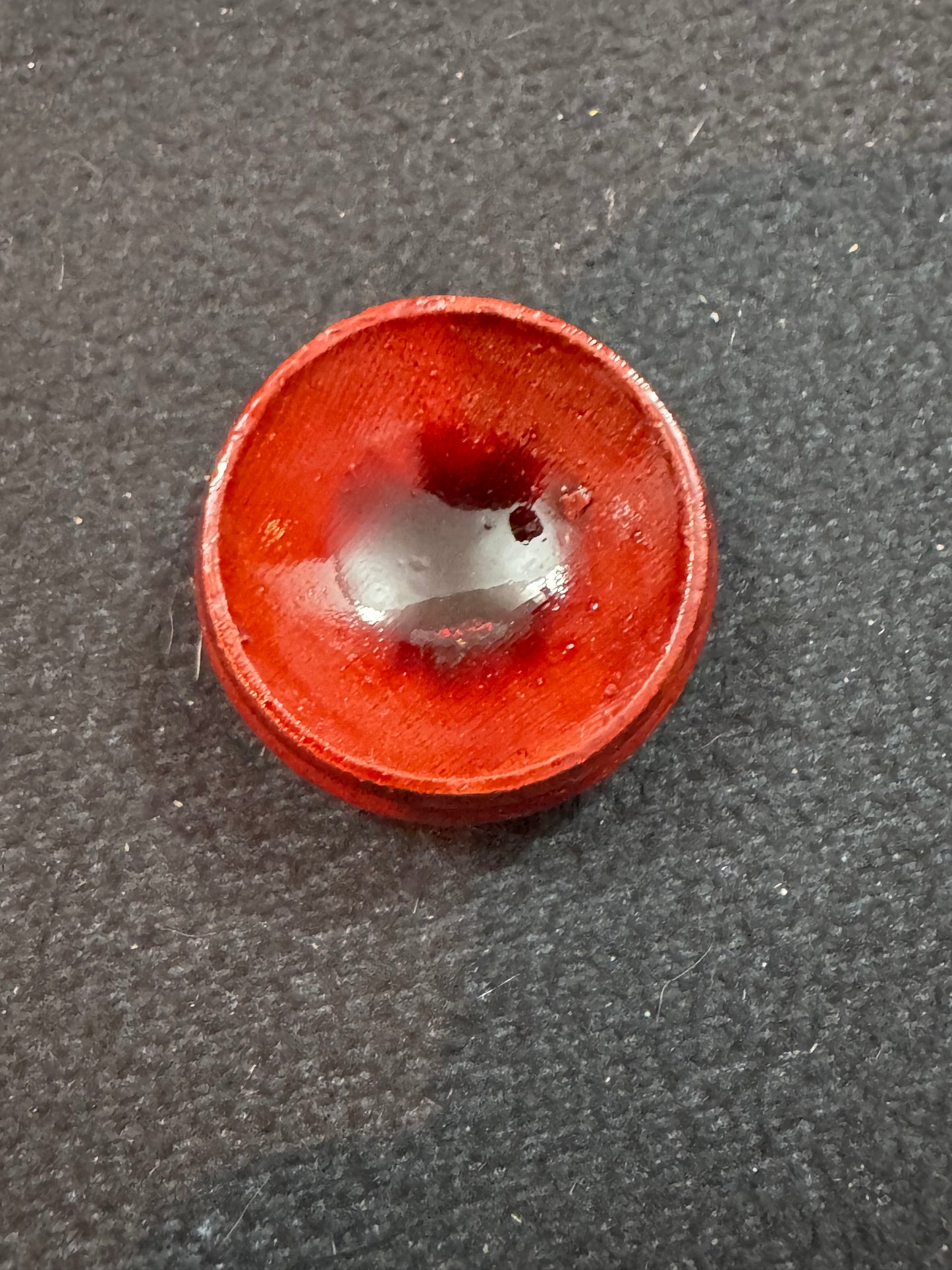 Red stand with a central hole on a gray background