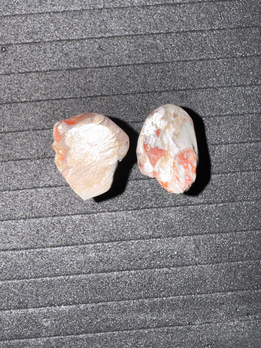 Two small stones on a textured gray surface