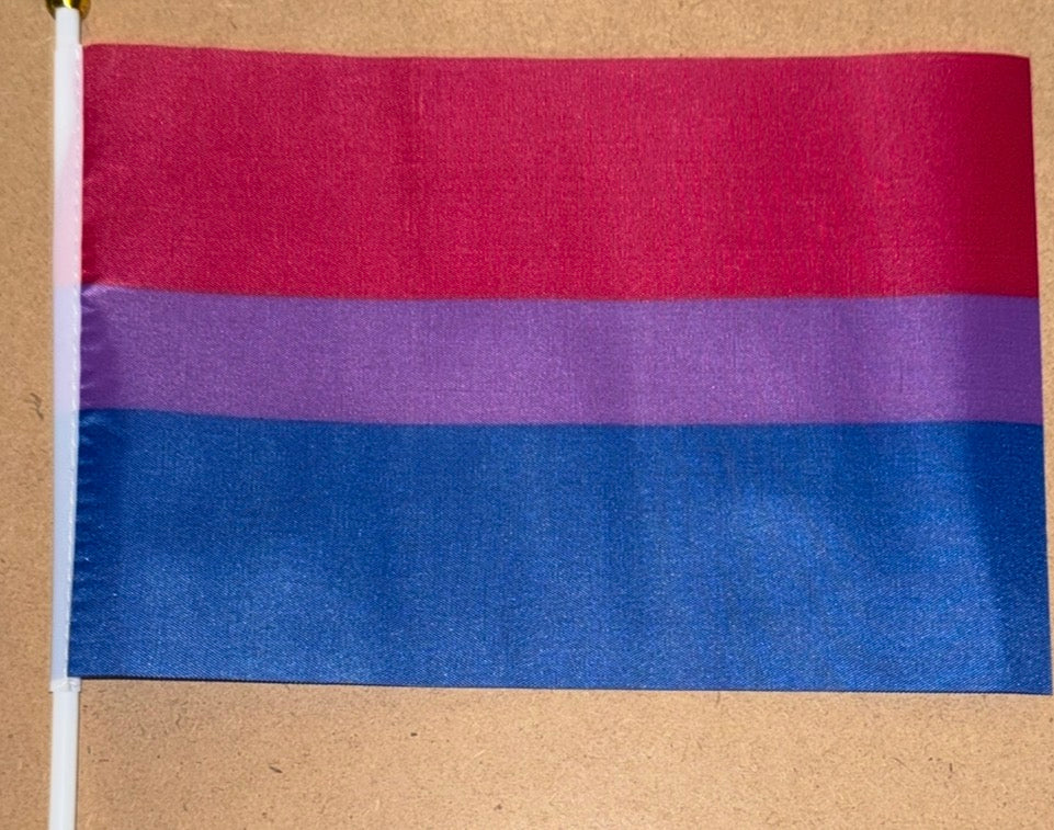 Bisexual pride flag with red, purple, and blue stripes on a beige background