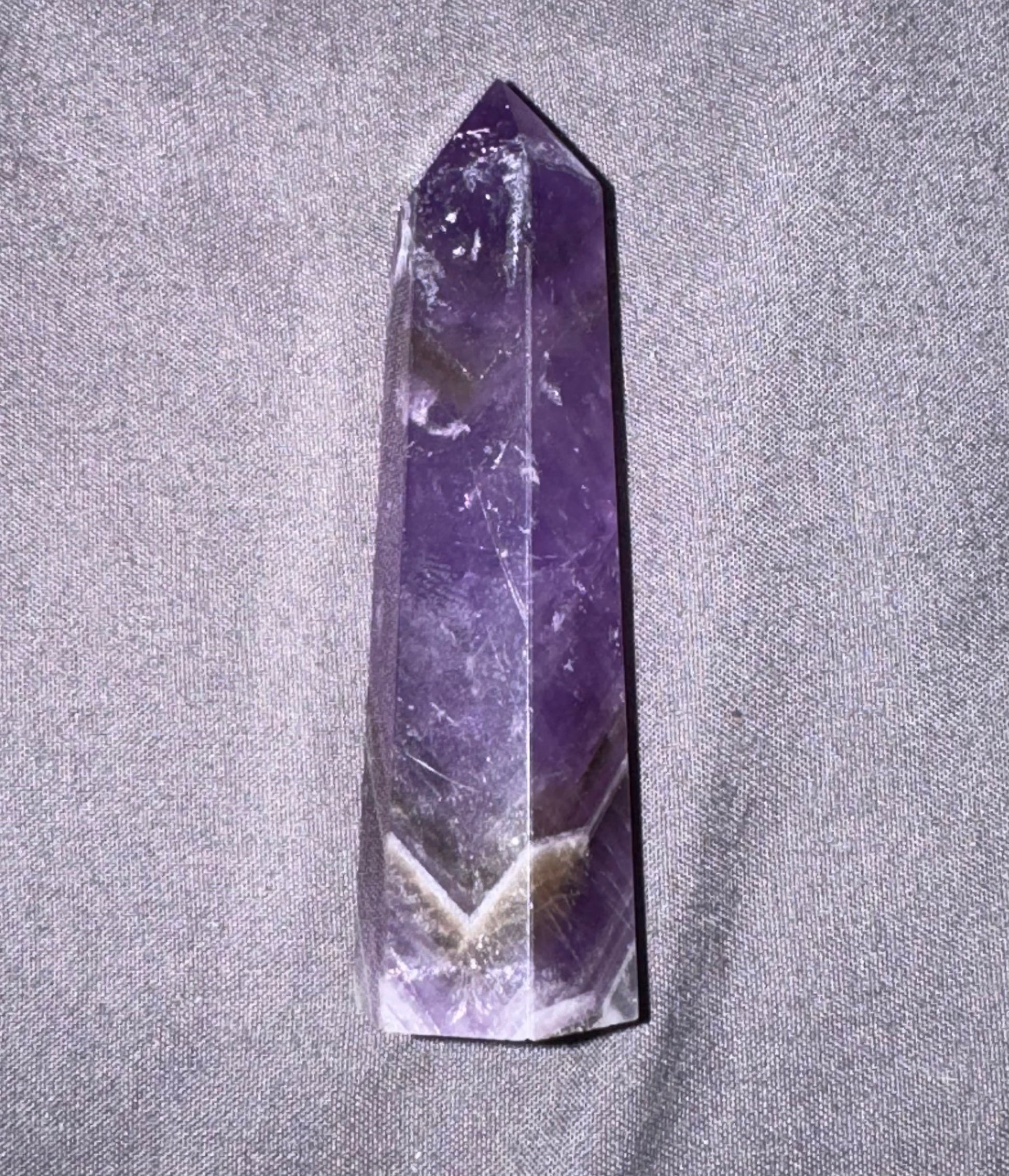 Amethyst crystal on a gray fabric background
