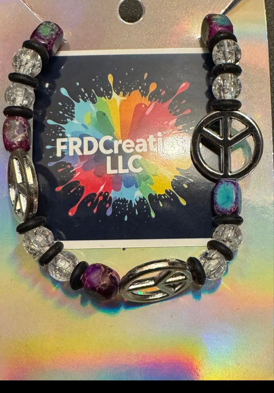 Bracelet with peace symbol bead on a colorful background 