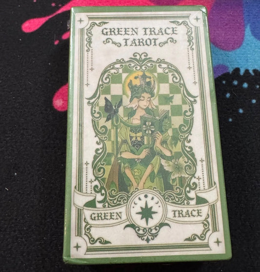 Green Trace Tarot card deck packaging with decorative design on a colorful background