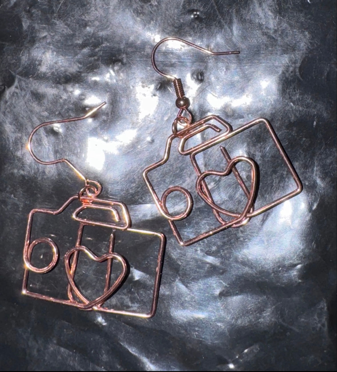 Copper colored camera shaped earrings 