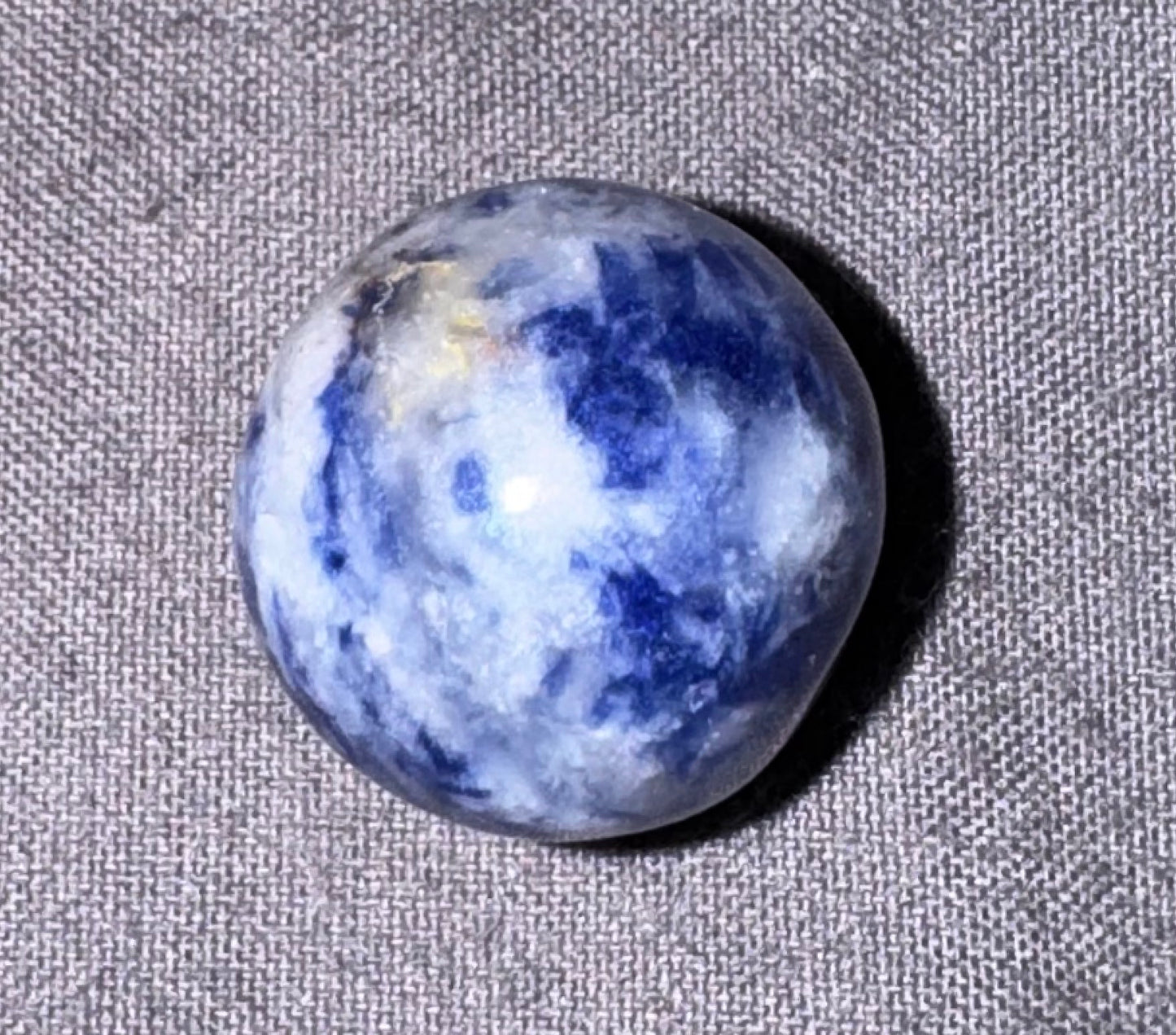 Blue and white marbled stone on a textured gray background