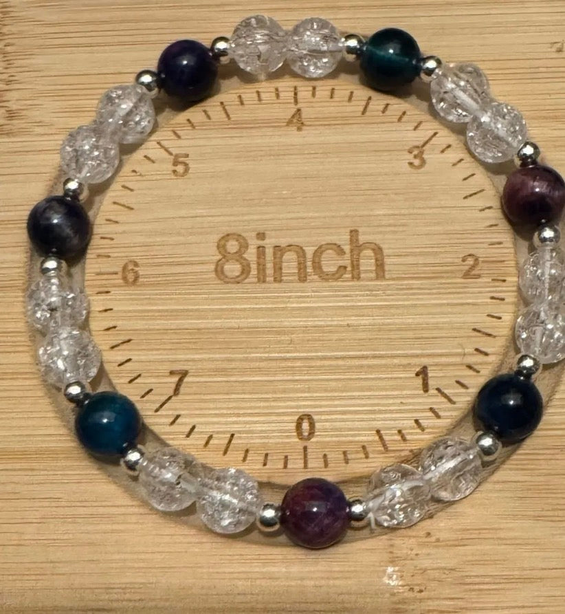 Tigeres eye and crackle  bracelet on a wooden ruler showing a length of 8 inches.