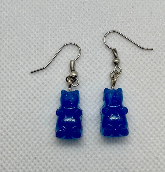Blue gummy bear-shaped earrings on a light gray background