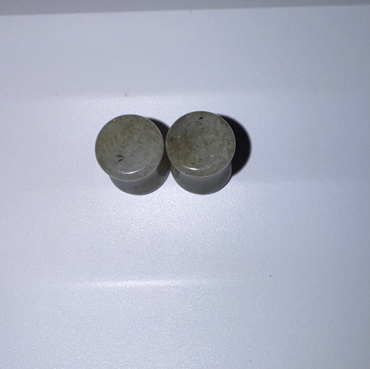 Two labradorite ear gauges on a white background