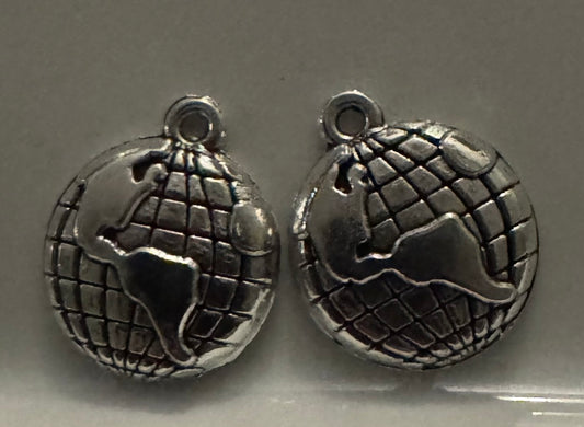 Two silver globe charms with raised continents and a grid pattern, shown on a plain gray background.
