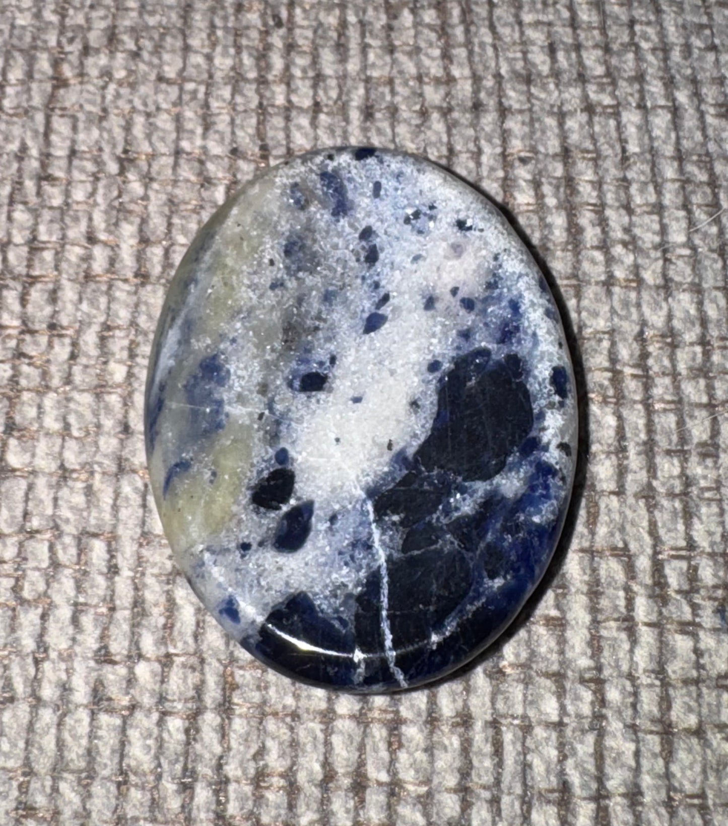 Speckled stone on a textured surface