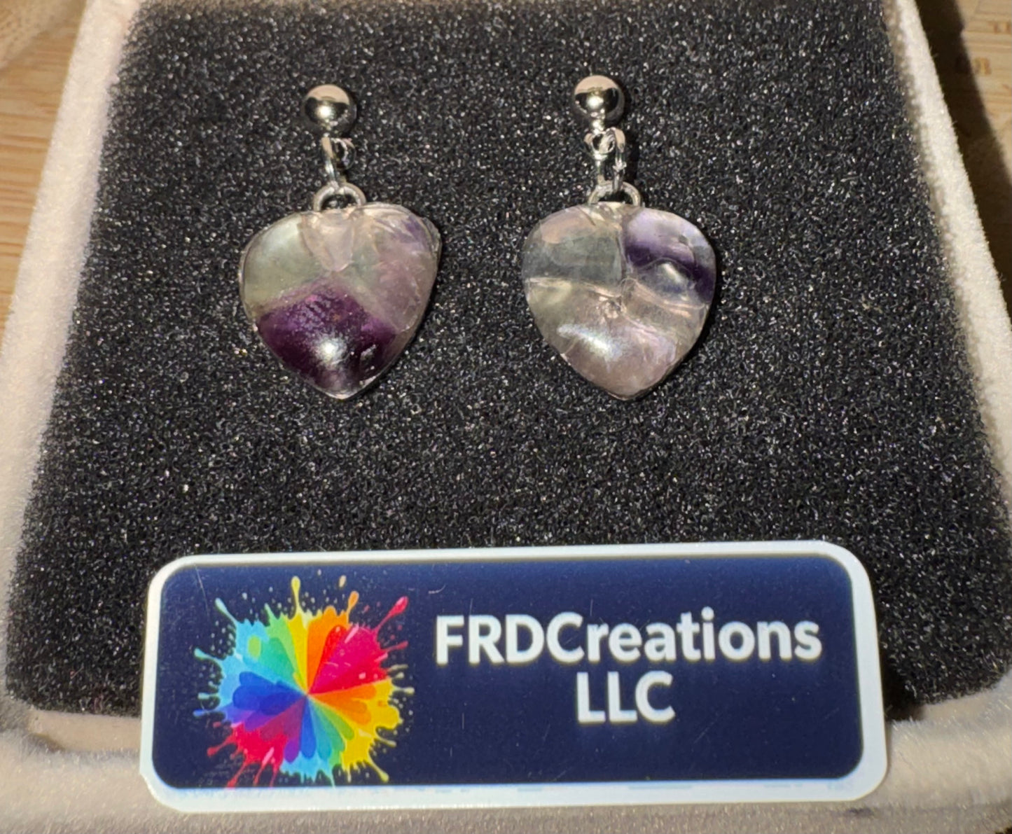 Heart-shaped earrings on a display card with FRDCreations LLC branding.