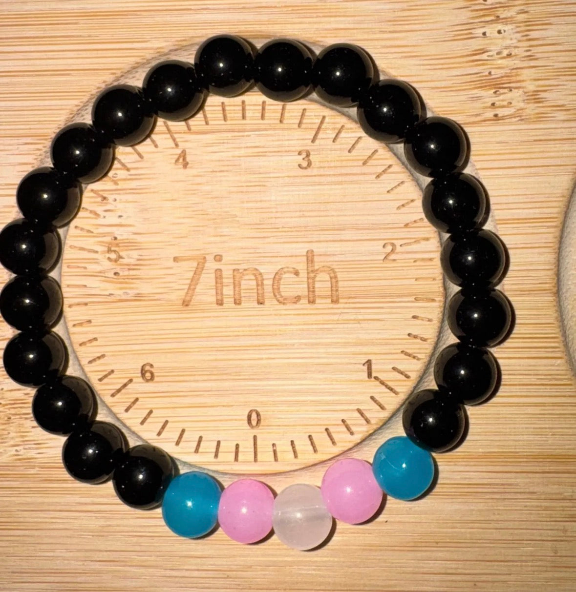 Black bead with subtle trans colors of blue, pink and white bracelet 