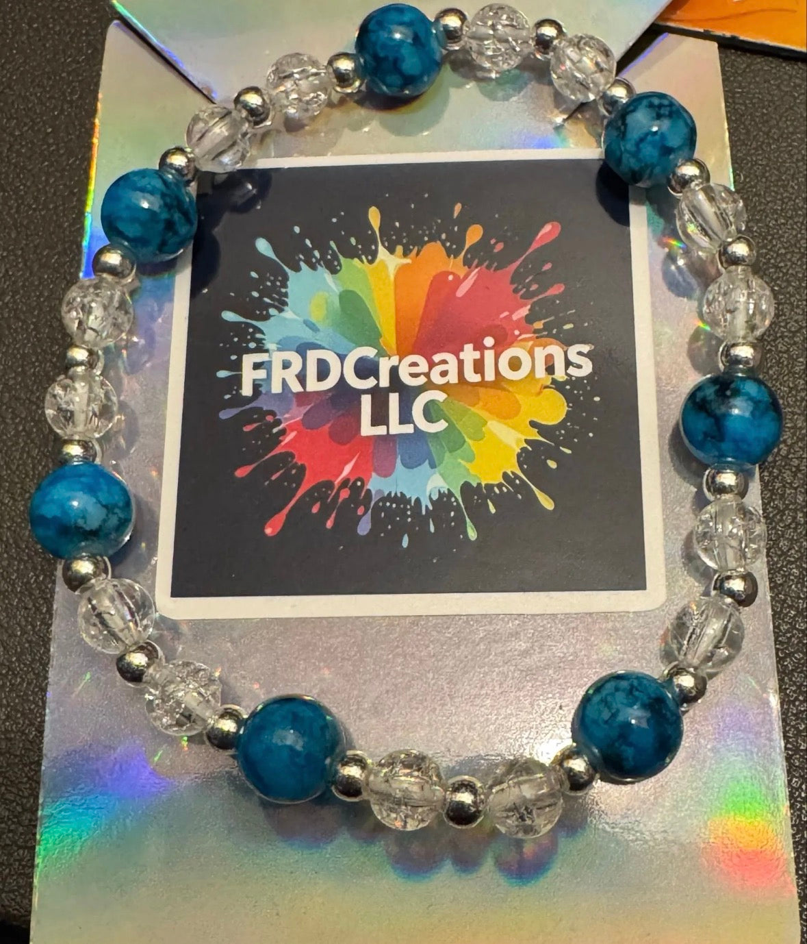 Beaded bracelet with blue and clear beads on a card 