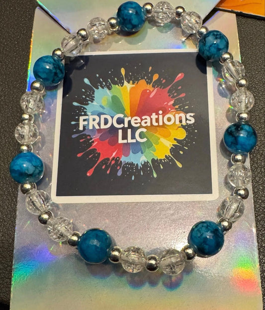 Beaded bracelet with blue and clear beads on a card 