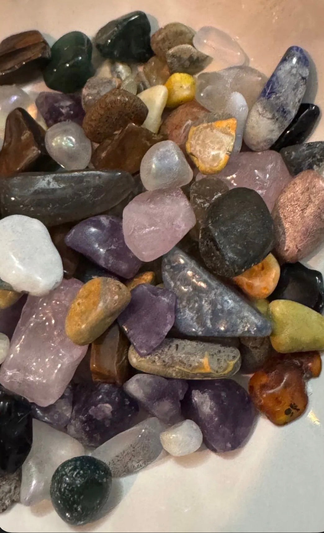 Assorted multicolored stones on a white surface