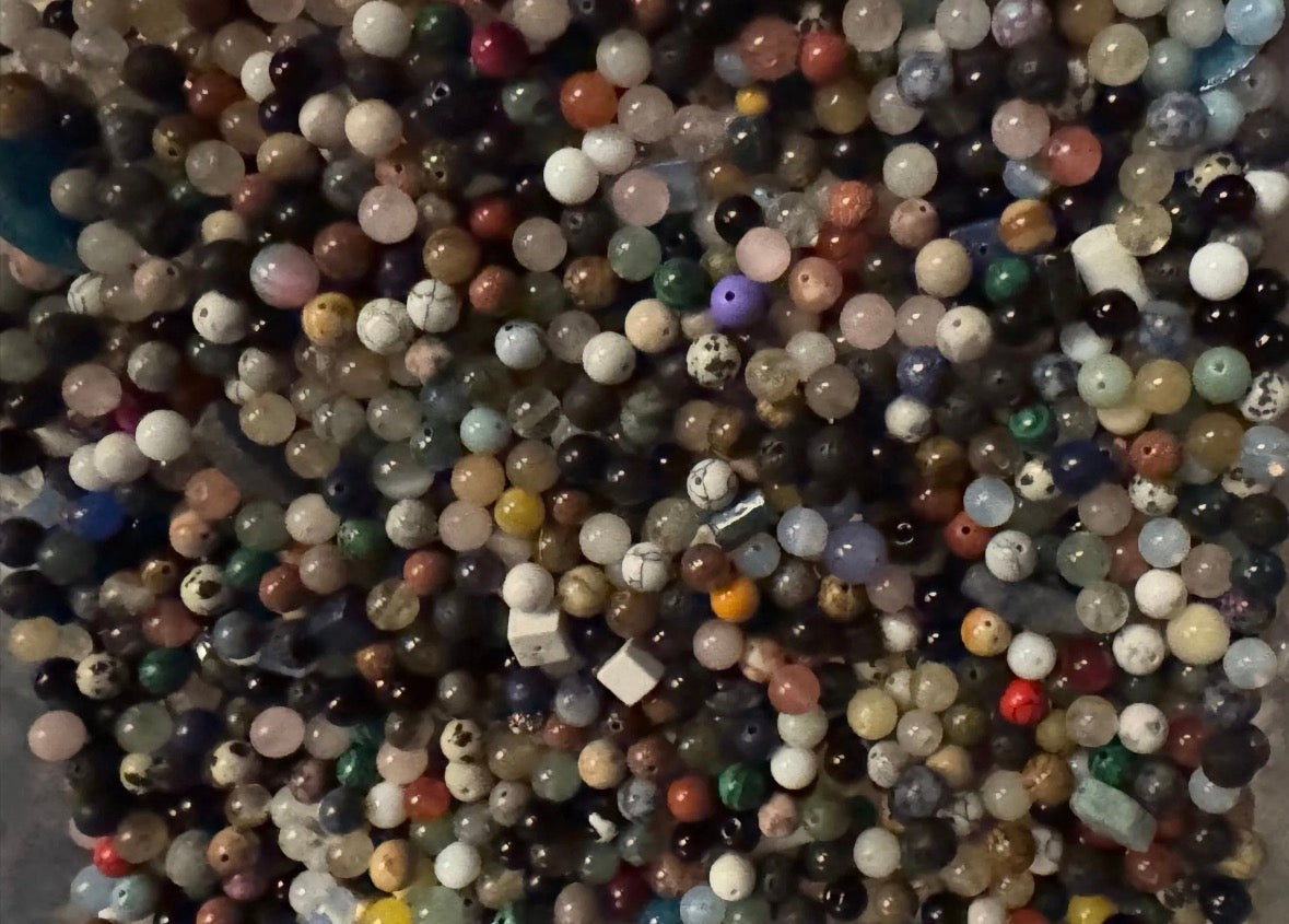 Assorted multicolored beads on a textured surface