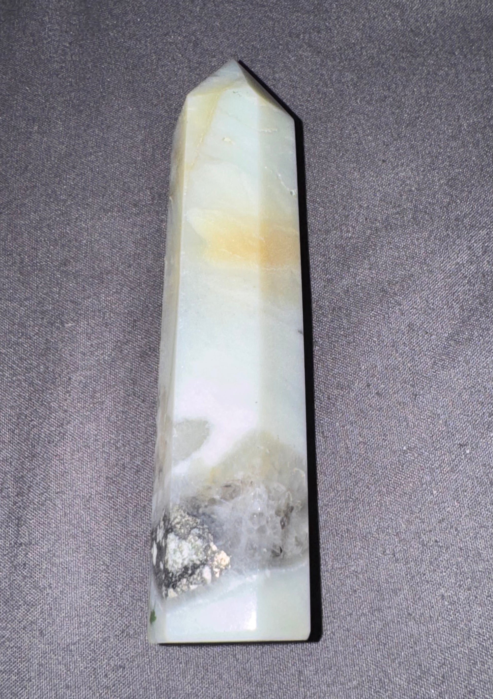 Decorative crystal obelisk on a gray background