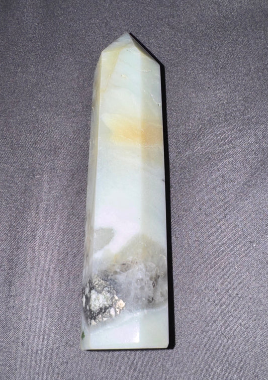 Decorative crystal obelisk on a gray background